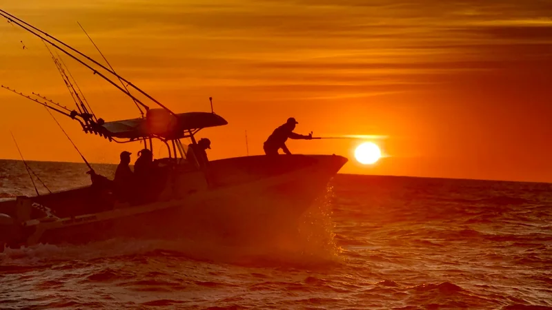 Fishing boat silhouetted at sunset Fishing boat silhouetted at sunset