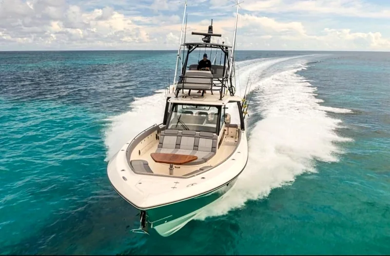 Motor yacht underway with a sweeping wake Motor yacht underway with a sweeping wake