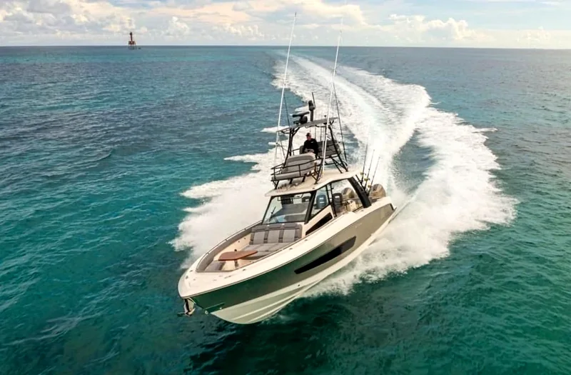 Motor yacht underway with a sweeping wake Motor yacht underway with a sweeping wake