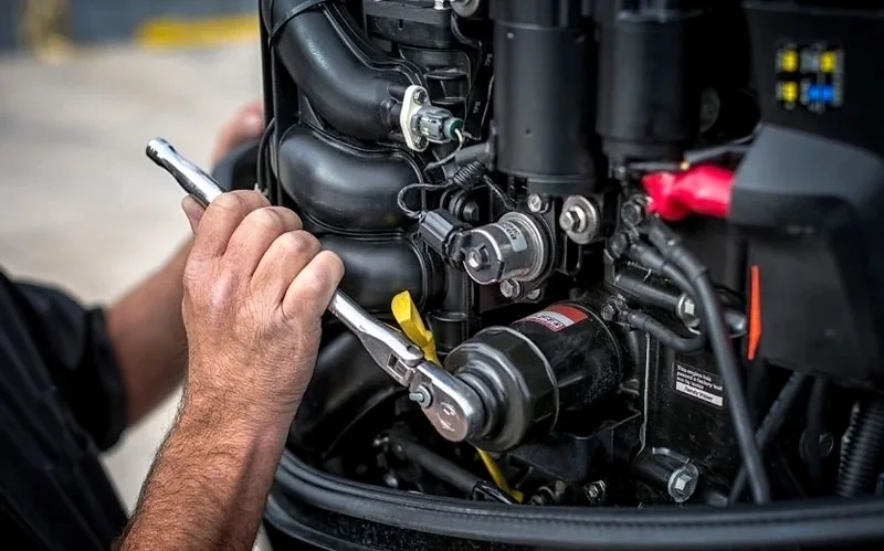 Technician servicing an outboard engine Technician servicing an outboard engine