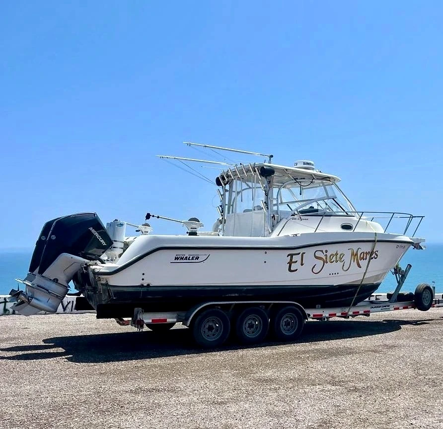 Sportfishing boat with outboard engines on land