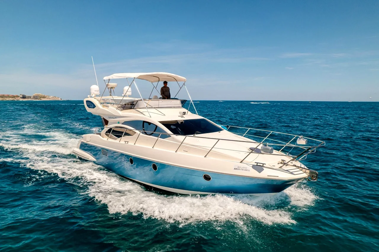 Motor yacht cruising on open water Motor yacht cruising on open water