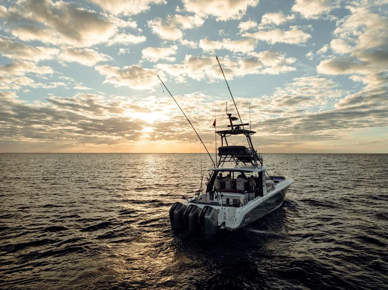 Sportfishing boat on calm water at sunrise Sportfishing boat on calm water at sunrise